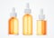 Set of different orange cosmetic serum dropper bottles, skin care product packaging concept, commercial design deady