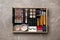 Set of different professional makeup products in box on table