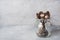 A set of different teaspoons in a glass jar. Gray background with copy space