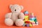 Set of different toys on orange background