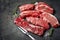 A set of different types of raw beef steaks: rib eye, Striploin, Denver, machete, top blade