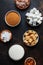 Set of different white and brown sugar in assortment, dark background, top view