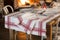 Set Dinnerware and Tablecloth with Red Stripes Near Blazing Fire