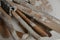 Set of dirty art and craft sculpting tools on wooden table in pottery workshop