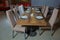 Set of a dish with spoon, fork and knife on wooden table. Empty Table setting on woo den table in restaurant served for dinner .