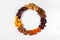 A set of dried berries, fruits and nuts in the form of a wreath hazelnut,pumpkin, cherry, apricot, Apple, dates, on a white