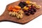 A set of dried fruits for a healthy diet - raisins, dried apricots, walnuts, cranberries on a kitchen wooden board. Delicious and