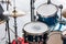 Set of drums, cymbals and microphones on pavement background
