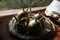 A set of dusty bronze tea kettles on a metal plate