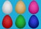 Set of Easter chicken eggs of different colors with ethnic geometric curly pattern on a light blue background.