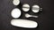 Set of empty ceramic dishes for sushi and rolls on a black stone table