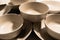 Set of empty and clean ceramic bowls and plates with simple round and curved shapes