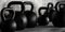 Set of fitness gym kettlebells in concrete room background, muscle exercise, bodybuilding or fitness concept