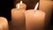 Set of five burning candles on a stone background