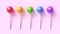 Set of five colorful sweet lollipops on pink pastel background