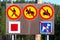 A set of five road signs located on a wooden stand