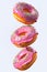 Set of flying glazed donuts with sprinkles on a white background