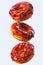 Set of flying glazed donuts with sprinkles on a white background