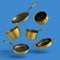 Set of flying stewpot, frying pan and chrome plated cookware on blue background