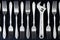 Set of forks, and wrench on a black background