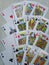 Set of four aces, kings, queens and jacks from a deck of playing cards. Organized over white background.