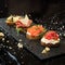 set of four bruschettas on a black marble table
