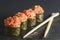 Set of four pieces of spicy Maki sushi rolls with sauced slices of smoked Eel, cheese and caviar of flying fish.