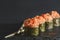 Set of four pieces of spicy Maki sushi rolls with sauced slices of smoked Eel, cheese and caviar of flying fish.