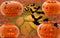 Set of four pumpkins with glowing eyes for a festive day of Halloween cute spider and flies with brick-autumn background