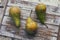 Set of fresh conference pears on wooden background.