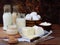 Set of fresh dairy products on wooden background: milk cheese cottage yogurt egg mozzarella ryazhenka feta.