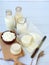 Set of fresh dairy products on wooden background: milk, cheese, cottage, yogurt, egg, mozzarella, ryazhenka, feta.