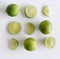 Set of fresh whole and cut lime and slices isolated on white background. From top view. Rich of nutrients, fiber, and vitamins.