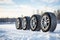Set of friction winter wheels with aluminum alloy wheels on a winter background