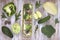 Set of fruits and vegetables on white painted wooden background: kohlrabi, cucumber, apple, pepper, cabbage, broccoli, avocado, ru