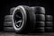 Set of fuel efficient car tires on dark background. Winter and summer tire tread.