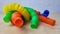 A set of funny plastic multicolored tubes-antistress on a wooden background