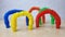 A set of funny plastic multicolored tubes-antistress on a wooden background