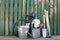 Set of gardening tools near fence