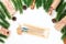 set of gift-wrapped craft pens in frame of Christmas tree branches and cinnamon bundles on white insulated background