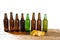 Set glass bottles of beer mock up with no label and potato chips on wooden table isolated, copy space