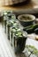 Set of glass jars with fresh cucumbers prepared for canning on table