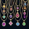 set of gold jewelry pendants with precious stones on chains