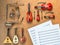 Set of golden brass wind orchestra instruments: saxophone, trumpet, french horn, trombone and crumpled sheet music lying near it.