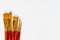 Set of golden bristle paint brushes on white background with copy space