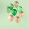 Set of green and golden glossy balloons on the stick with sparkles on green background. 3D render for birthday, party, wedding or