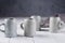 Set of grey rustic coffee cup handcraft against shabby grey wall. Handmade crockery tableware