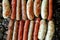 Set of grilled sausages cooked on barbecue grill detailed