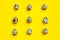 Set of group quail eggs in a row on a yellow background