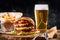 Set of hamburger beer and french fries. A standard set of drinks and food in the pub, beer and snacks. Dark background